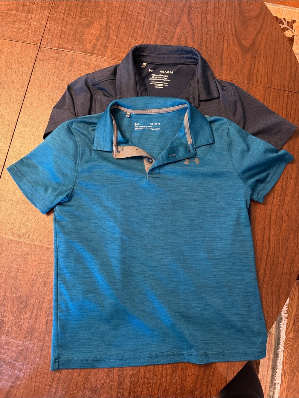Bundle of two youth L Under Armour Short-Sleeve Polos one navy and one teal